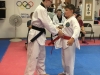 Mr. McElwrath putting red belt on his brother Hunter